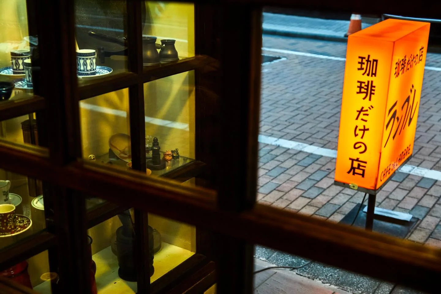 Photo by カフェ・ド・ランブル on May 26, 2026. May be an image of lantern, signboard, display case and window.