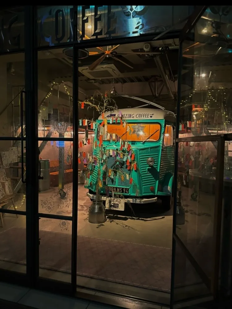 Photo shared by AMAZING COFFEE official on June 29, 2026 tagging @ldh_japan_official. May be an image of trolley, cablecar, bus, display case, shuttle bus, terminal and text.