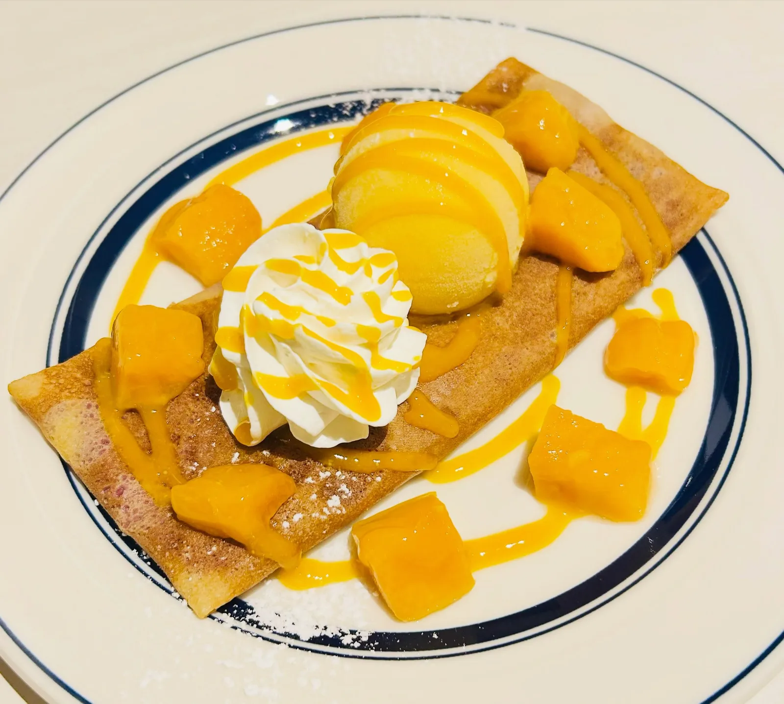 Photo by CREPERIE CAFE ガレット屋 AILES on August 01, 2026. May be an image of mango, whipped cream and text.